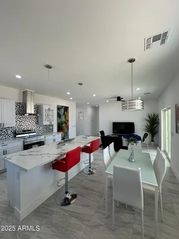 a living room with furniture and kitchen view
