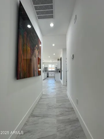 a view of a hallway with wooden floor
