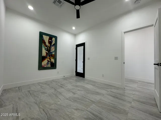 an empty room with windows and closet