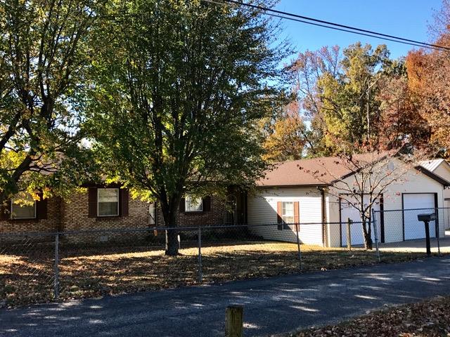 140 Parks Road Portland, TN 37148 - Photo 3 of 19 a front view of a house with trees and covered with wooden fence