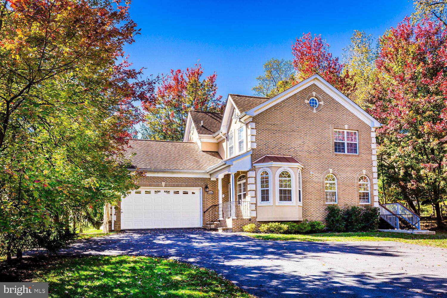 5642 Waterloo Road Columbia, MD 21045 - Photo 1 of 67 Charming brick home amidst vibrant autumn hues.