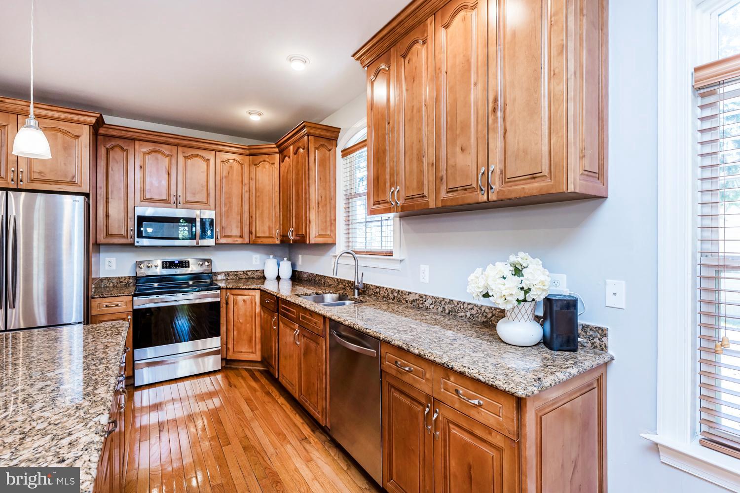 5642 Waterloo Road Columbia, MD 21045 - Photo 16 of 67 Warm wood tones in a modern kitchen.