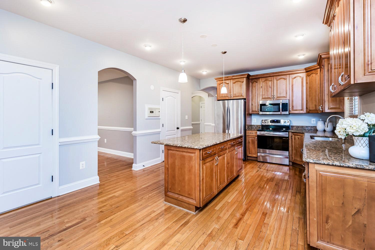 5642 Waterloo Road Columbia, MD 21045 - Photo 17 of 67 Modern kitchen with rich wood cabinetry.