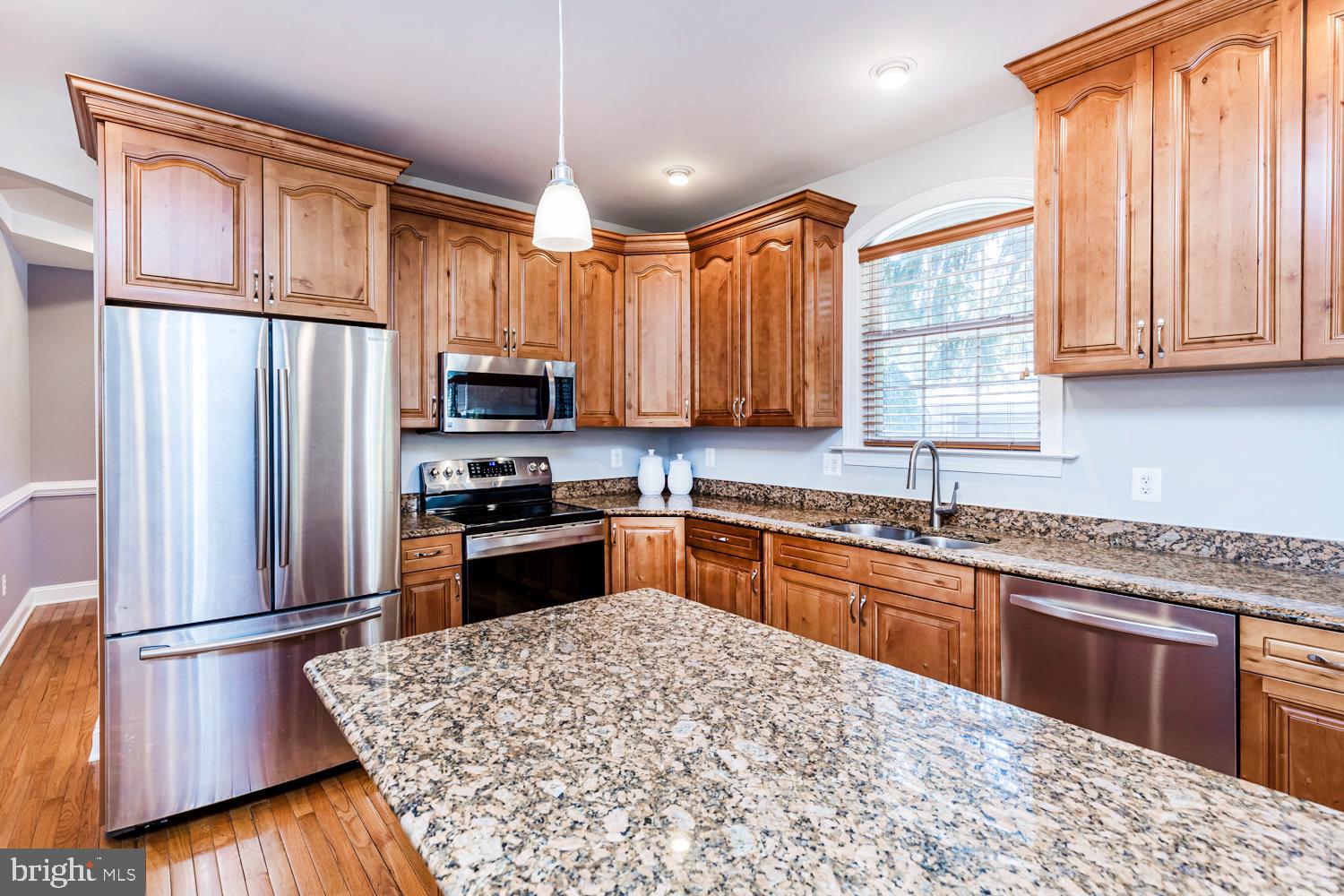 5642 Waterloo Road Columbia, MD 21045 - Photo 19 of 67 Elegant kitchen with rich wood cabinetry.