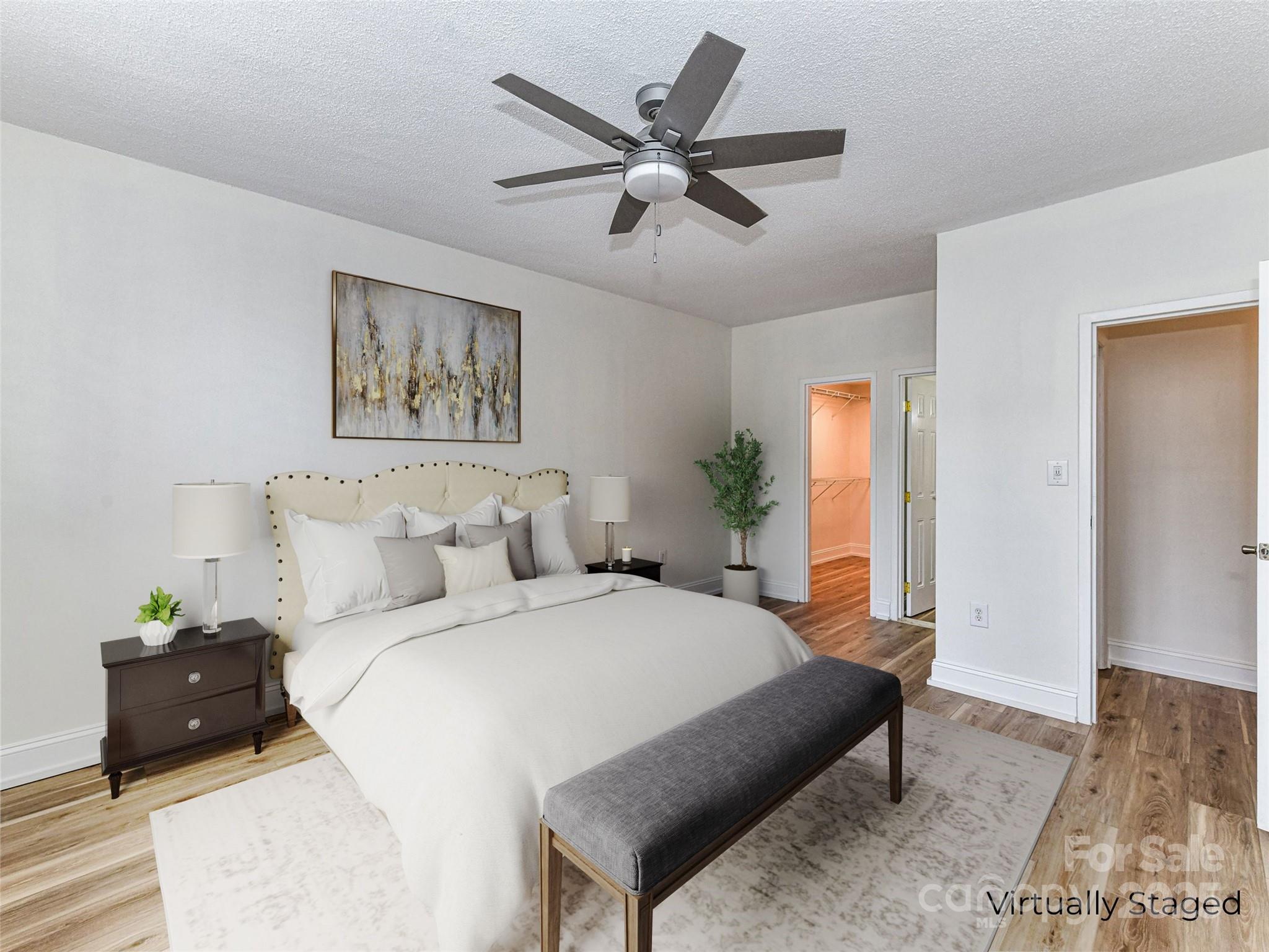 1300 Reece Road, Unit 111 Charlotte, NC 28209 - Photo 11 of 29 a bedroom with a bed and a chandelier