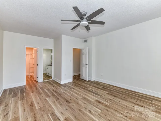 a view of an empty room and wooden floor