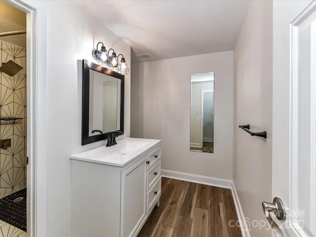 a bathroom with a sink toilet and mirror