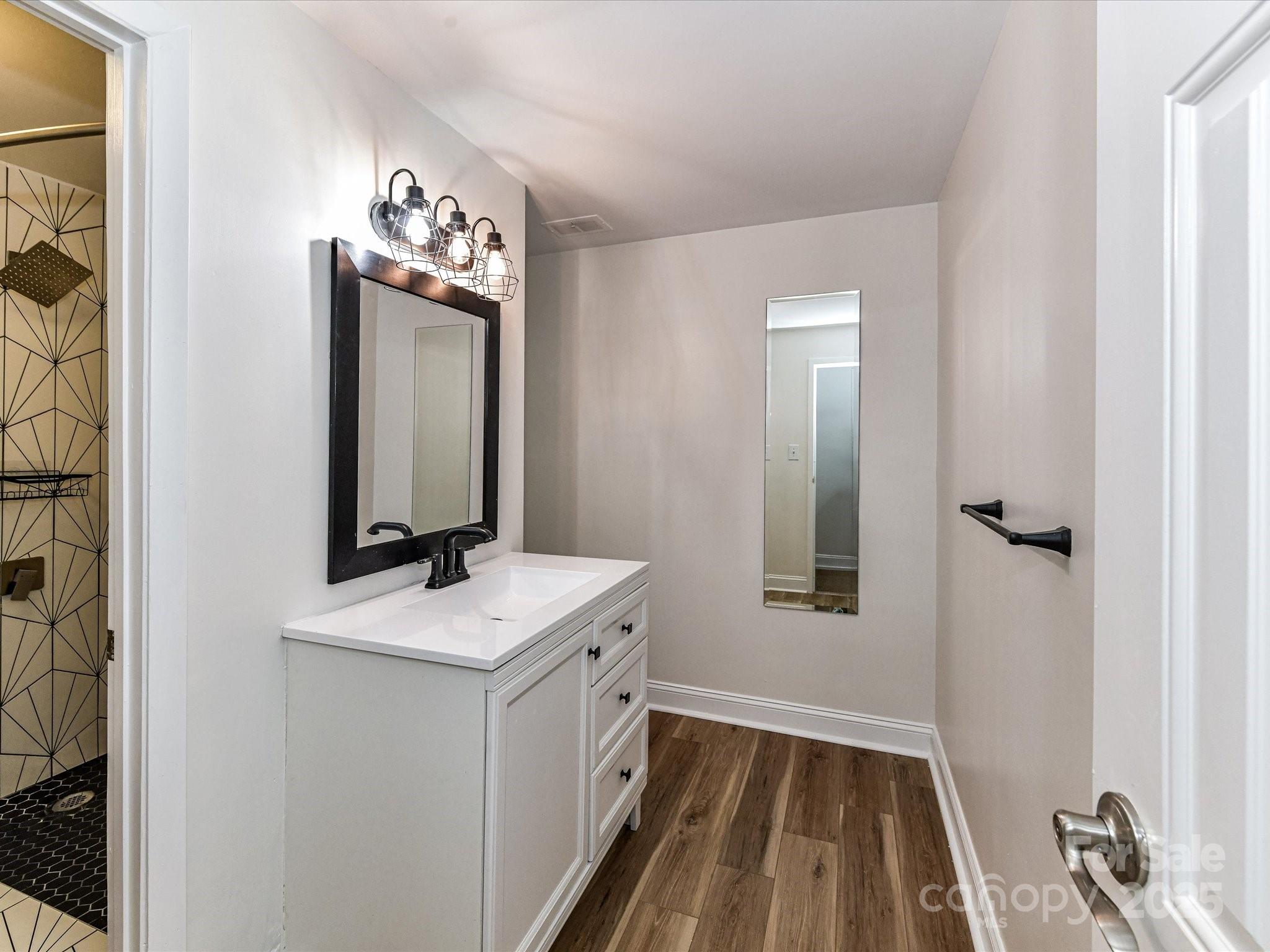 1300 Reece Road, Unit 111 Charlotte, NC 28209 - Photo 18 of 29 a bathroom with a sink toilet and mirror