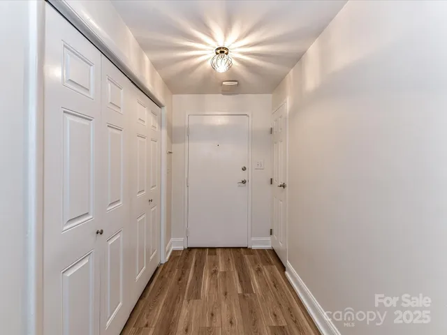 a view of a hallway with a chandelier fan