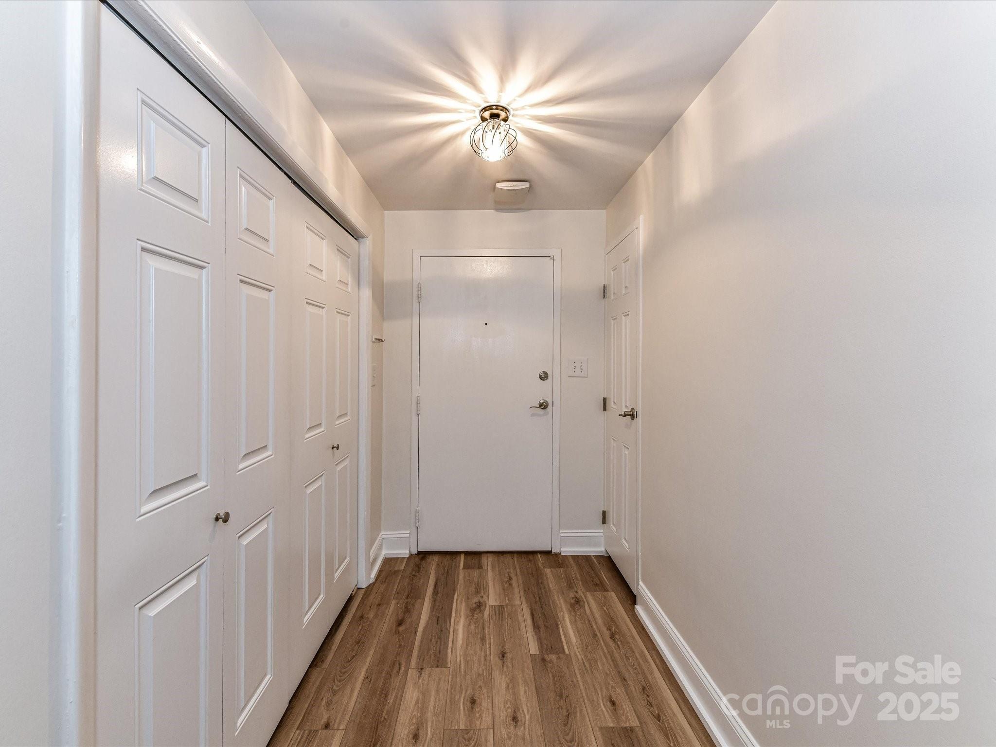 1300 Reece Road, Unit 111 Charlotte, NC 28209 - Photo 5 of 29 a view of a hallway with a chandelier fan