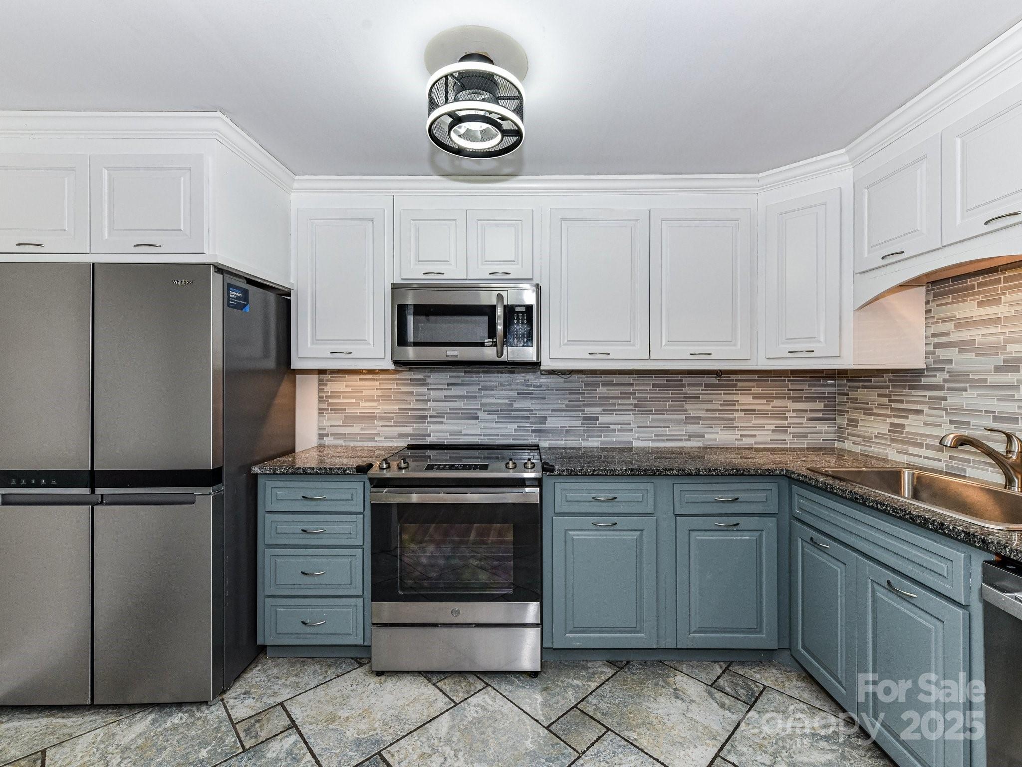 1300 Reece Road, Unit 111 Charlotte, NC 28209 - Photo 7 of 29 a kitchen with granite countertop a stove top oven microwave and cabinets