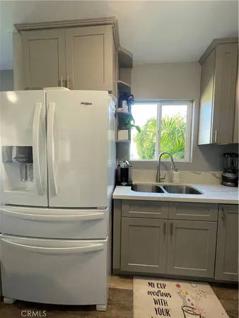 a kitchen with a sink a stove and cabinets