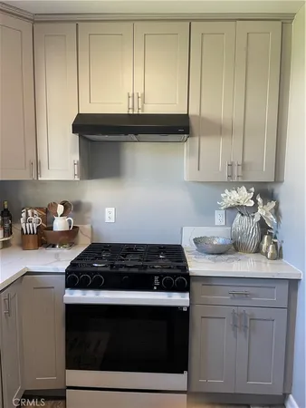 a kitchen with granite countertop cabinets and white stove