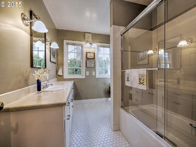 7524 Southwest View Point Terrace Portland, OR 97219 - Photo 14 of 16 a bathroom with a granite countertop sink a toilet a bathtub and shower