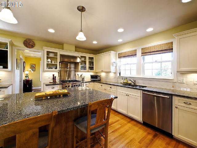 7524 Southwest View Point Terrace Portland, OR 97219 - Photo 5 of 16 a kitchen with sink stove and chairs