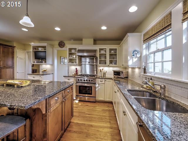 7524 Southwest View Point Terrace Portland, OR 97219 - Photo 6 of 16 a kitchen with stainless steel appliances granite countertop a sink and stove