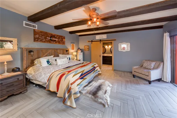 a bedroom with furniture and a flat screen tv