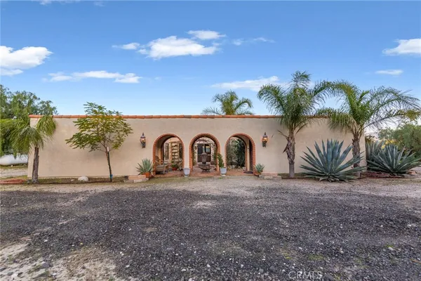 a view of a patio with table and chairs potted plants