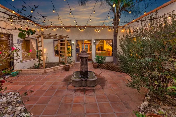 a view of swimming pool with outdoor seating and plants
