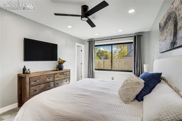 a bedroom with a large bed and a flat screen tv