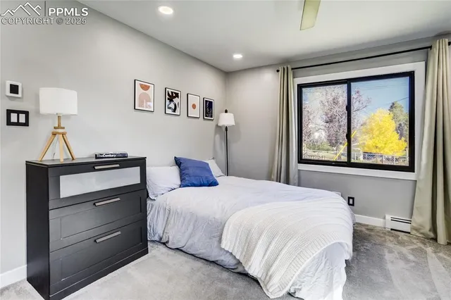 a bedroom with a bed a desk and chair