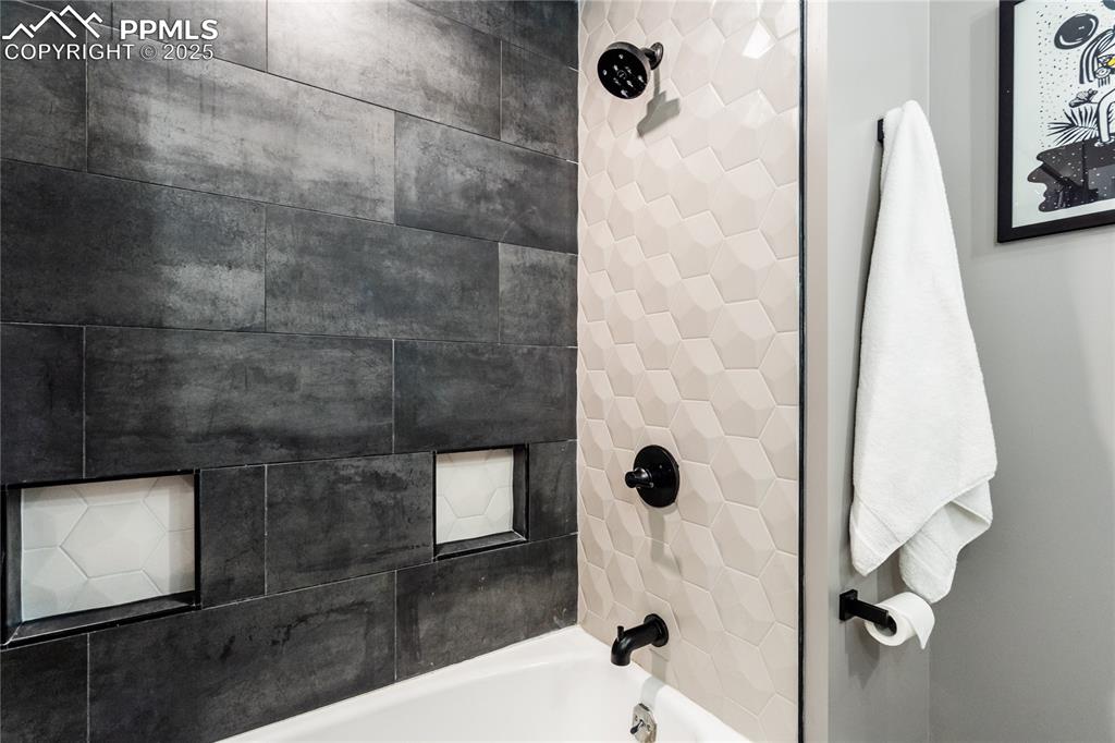 204 Mitchell Avenue Monument, CO 80132 - Photo 34 of 46 a bathroom with a shower and mirror