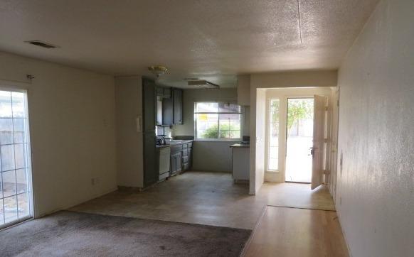113 West Clark Street Madera, CA 93638 - Photo 3 of 11 a view of a hallway with a kitchen