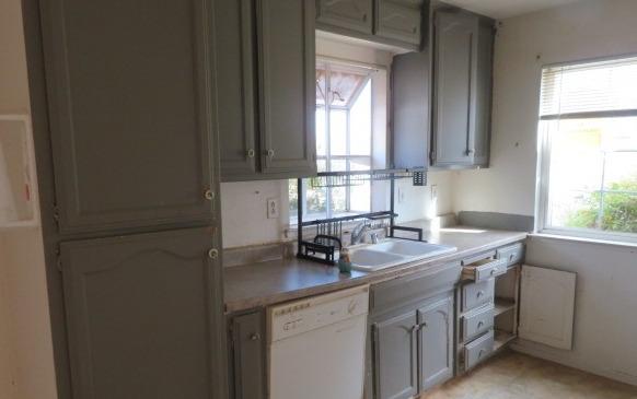 113 West Clark Street Madera, CA 93638 - Photo 4 of 11 a kitchen with a sink cabinets and window