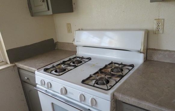 113 West Clark Street Madera, CA 93638 - Photo 5 of 11 a stove top oven sitting inside of a kitchen