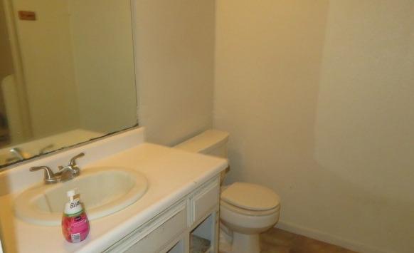 113 West Clark Street Madera, CA 93638 - Photo 6 of 11 a bathroom with a sink and a toilet