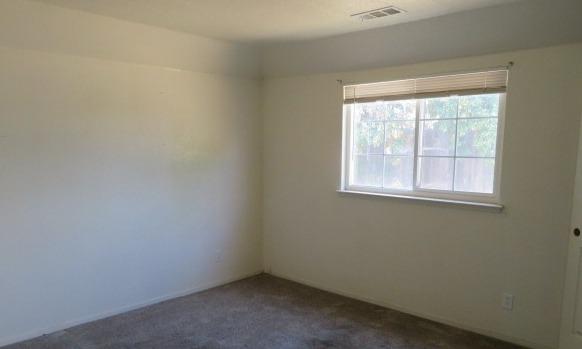 113 West Clark Street Madera, CA 93638 - Photo 8 of 11 an empty room with a window
