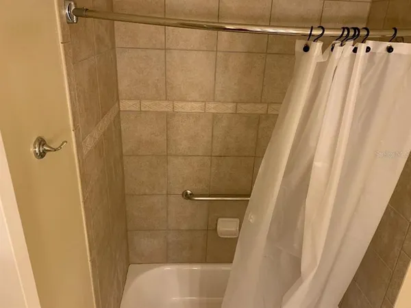 a bathroom with a shower and a shower