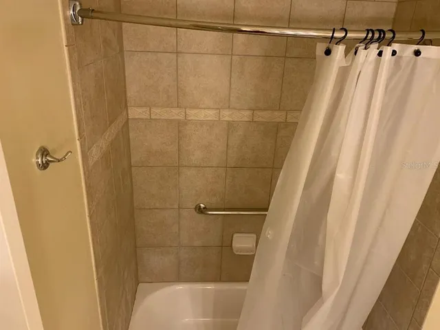 a bathroom with a shower and a shower