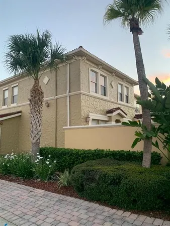 a front view of a house with a garden and plants