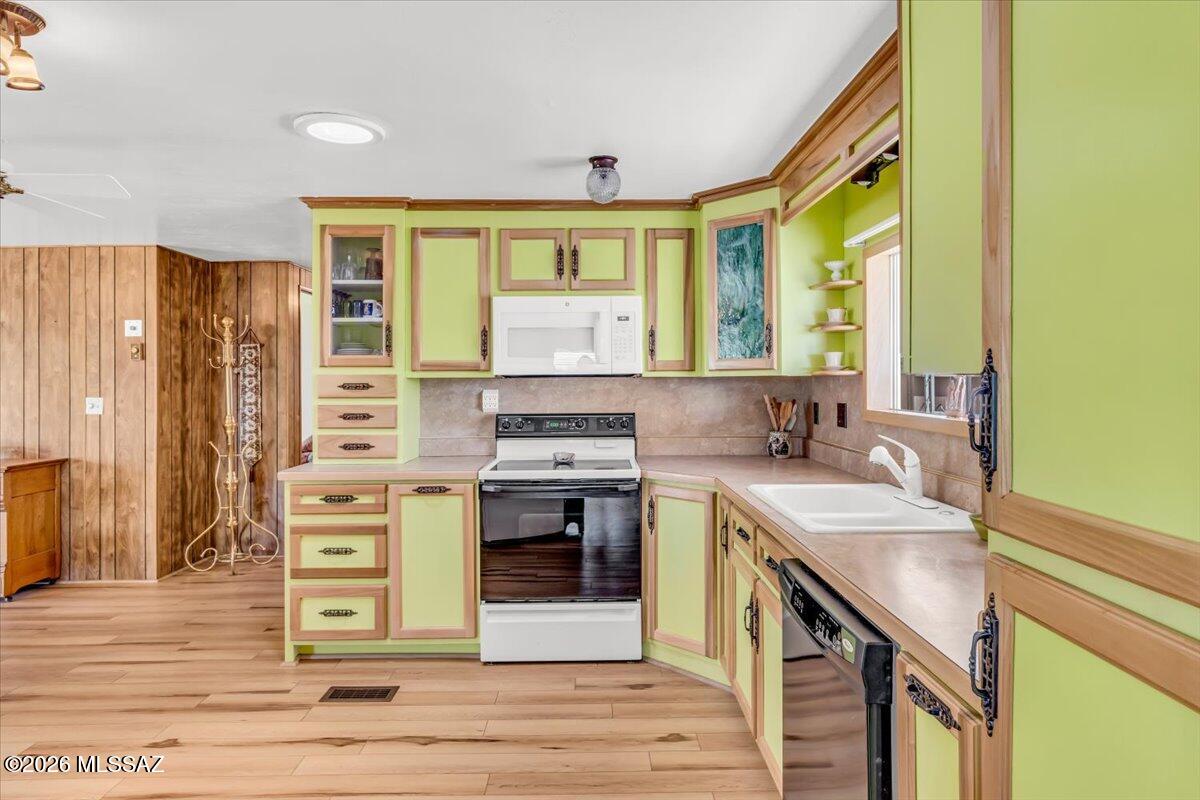 5840 West Flying W Street Tucson, AZ 85713 - Photo 7 of 38 a kitchen with a sink stove and cabinets