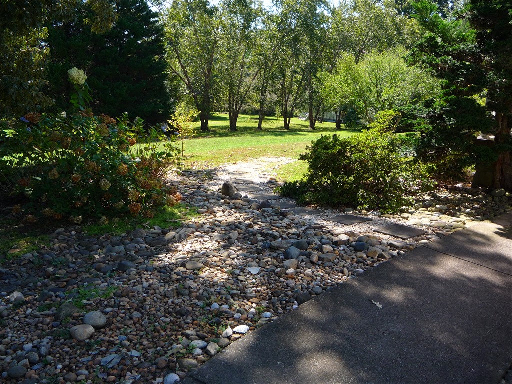 109 Lake Ridge Circle Walhalla, SC 29691 - Photo 26 of 27 Mature trees frame a peaceful pathway winding through beautifully landscaped grounds.