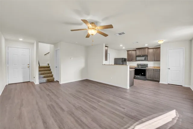 a view of a kitchen with wooden floor and a kitchen