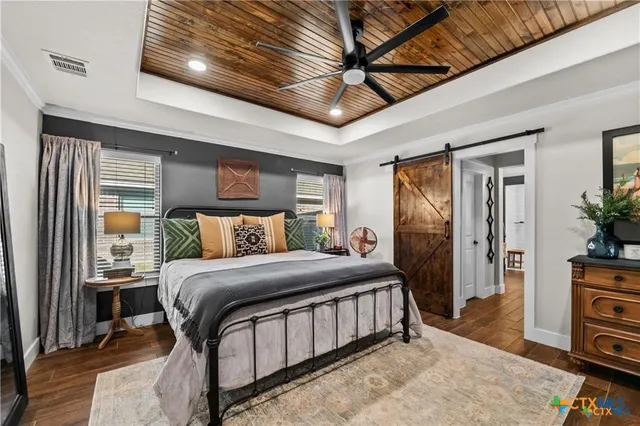 a bedroom with a bed next to a window