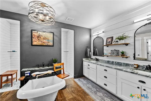 a bathroom with a sink a mirror and a lamp