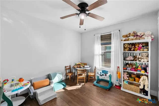 a living room with lots of furniture and a book shelf
