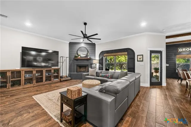 a living room with fireplace furniture and a flat screen tv