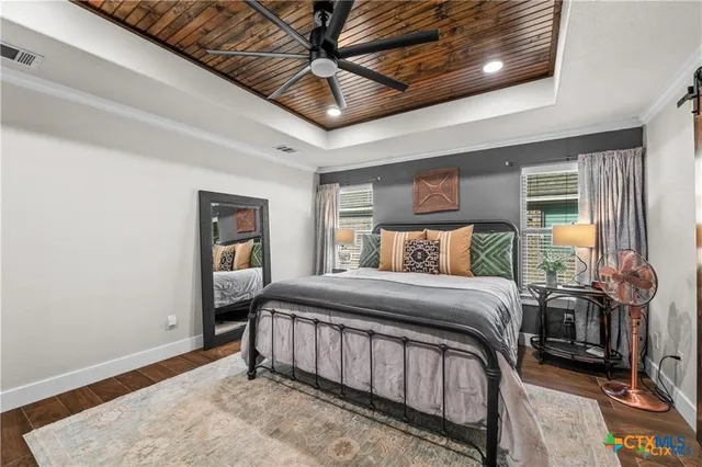 a bedroom with a bed and a chandelier