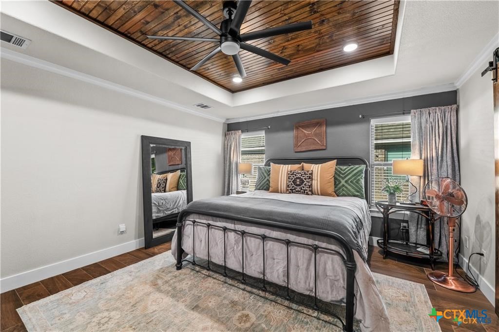 7306 Golden Heart Drive Temple, TX 76502 - Photo 10 of 25 a bedroom with a bed and a chandelier