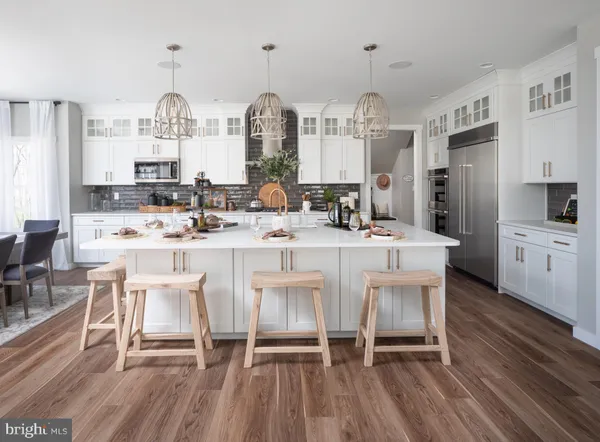 a large kitchen with a table and chairs