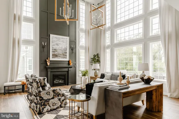 a living room with furniture and large windows