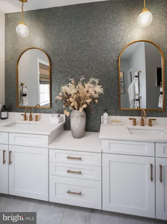 a bathroom with a sink mirror and