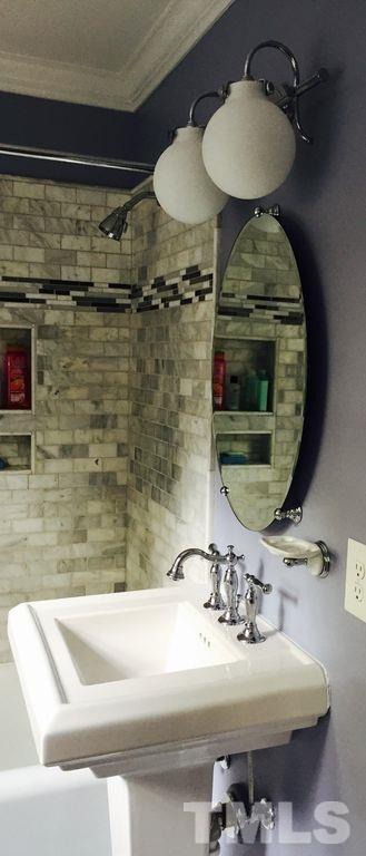 915 West Johnson Street Raleigh, NC 27605 - Photo 9 of 12 a bathroom with a sink and mirror