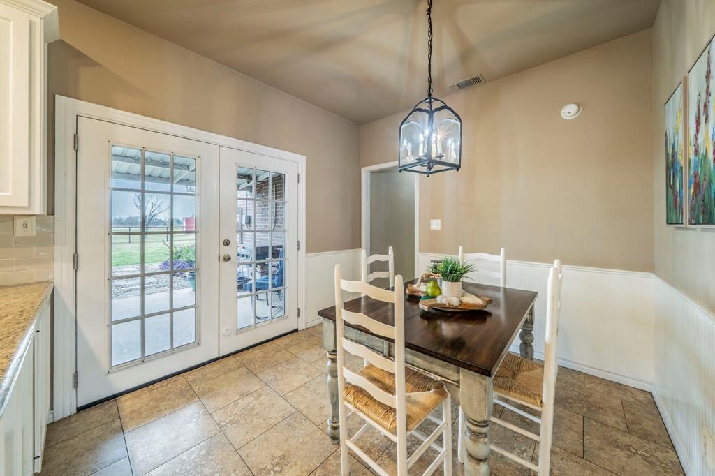 a dining room with furniture a chandelier and wooden floor
