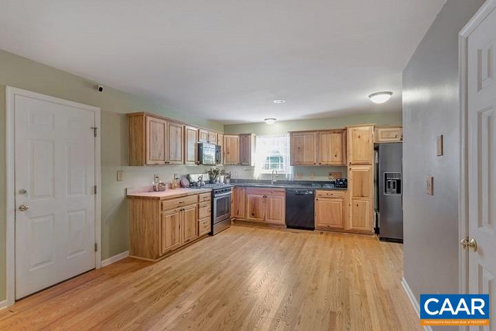 5 Cliftwood Road Palmyra, VA 22963 - Photo 6 of 49 a large kitchen with a wooden floor and a refrigerator