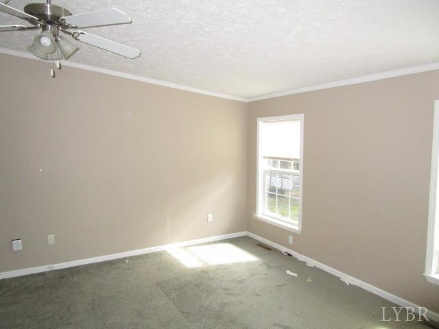 263 George Hairston Road Fieldale, VA 24089 - Photo 11 of 22 an empty room with windows and fan